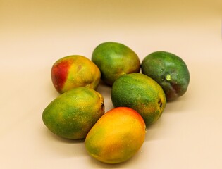 Texture background of fresh mangoes with water drops and center focus. Side blur with a clean background. 