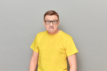 Obraz premium Portrait of angry irritated man with glasses grimacing from anger