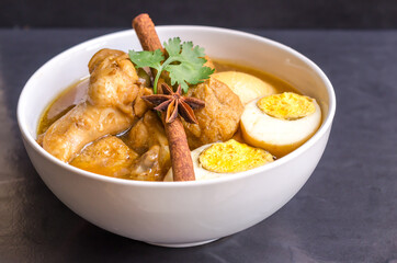 Eggs and chicken in brown sauce chicken stewed in the sweet brown Gravy,Hard boiled egg and stewed chicken in gravy sauce,Thai Cuisine call Kai Pha Lo