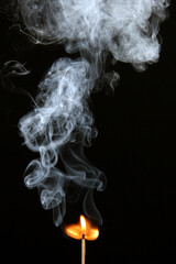 Burnt matches and smoke on black background. Studio shot