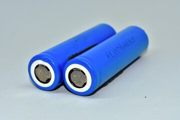 two rechargeable 18650 lithium-ion batteries. isolated on a white background. batteries for flashlights, vapes, electronic cigarettes, laptops