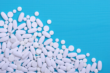 Heap of pills on blue