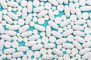 Heap of pills on blue