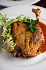 Duck. Prepared in classic French bistro style. Duck rendered in fat until skin is a crispy golden brown. Served with a frisee salad. 