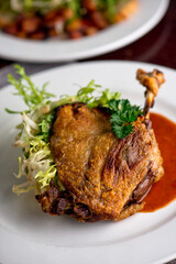 Duck. Prepared in classic French bistro style. Duck rendered in fat until skin is a crispy golden brown. Served with a frisee salad. 