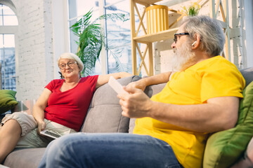 Talking. Couple of seniors spending time together being quarantined - caucasians mature and retired...