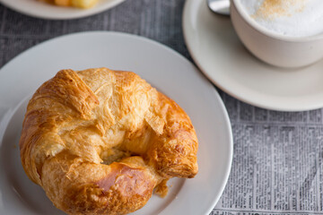 Croissants and assortment of breakfast pastries. Chocolate croissants, cinnamon rolls, and puff pastries filled with spinach and Asiago cheese served in a classic French Bistro. 