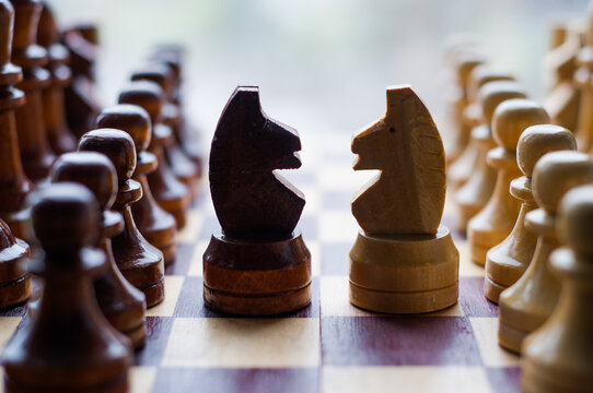 Chessmen on a chessboard, white background, Chess pieces on a chessboard