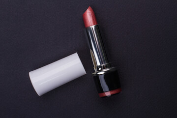 Trendy lipstick mock up with white caps. Black dark background. Studion shot from top.