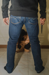 Fear woman sitting on ground with thief or robber standing in front of ( abuse concept, sexual abuse) ,Violence against women, Criminal and Sexual concept. Social issues and problem theme.