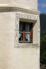 Traditional window of a white house with frescoed geometric decorations, Engadin valley, Graubunden canton, Switzerland, Europe