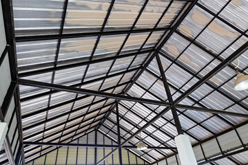 Steel roof structure. Moonlight bulb. Steel structure with roof tiles. Architectural structure of roof. Large roof layout used for industrial plants.