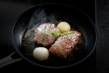 cooking at home - roasted game meat from the chamois buck with onions and rosemary