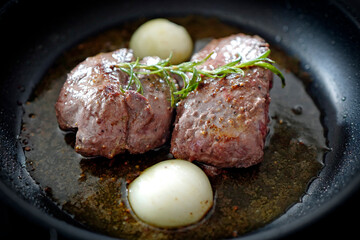 cooking at home - roasted game meat from the chamois buck with onions and rosemary
