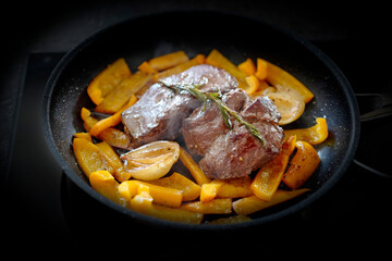 cooking at home - roasted game meat from the chamois buck with onions, paprika and rosemary