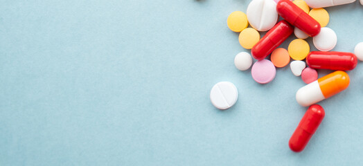multicolored pill pills on a blue background