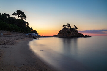 Long exposure view of the Cap Roig point sunrise and the beach of the same name. Catalonia, Spain
