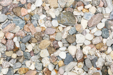 River stones texture. Gravel background. Various rocks pattern. Walking path by the water.