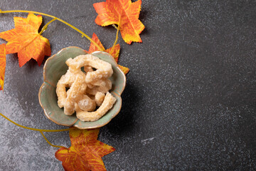 pork rind in a cup on a black background. Thai food