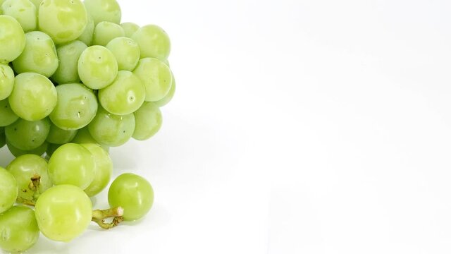 fresh green grapes fruit on white background, video footage.