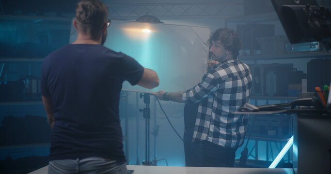 Costumer choosing light in video equipment store