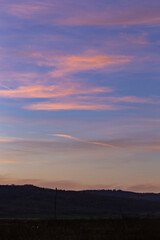 Purple-magenta clouds. Landscape with bloody  dawn. The terrain in southern Europe.  Panorama. Mirror lake with a reflection of nature. Morning silence. Water surface.