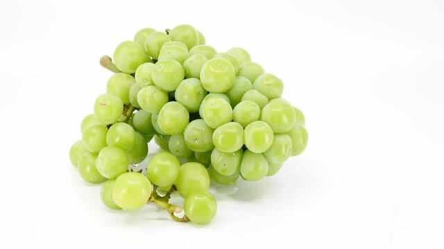 fresh green grapes fruit on white background, video footage.