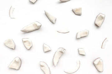 Raw coconut pieces pattern on a white background