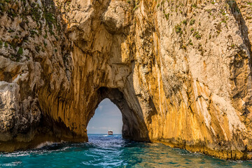 A close up view through the tunnel of love sea arch in the Faraglioni rocks on the eastern side of the Island of Capri, Italy