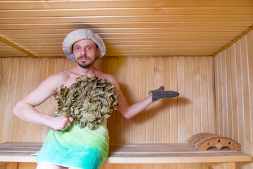 Funny man is sitting in the sauna. Wellness treatments in the steam room.