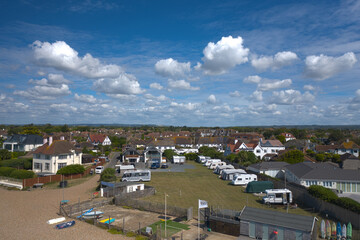 Fototapeta na wymiar Beautiful aerial view of East Preston beach front on a warm and sunny day with small cumulus clouds.