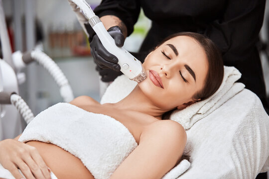 Beautiful Woman In Spa Salon Receiving Laser Depilation Theraphy For Her Chin