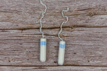 Female tampons on the wooden background. Woman hygiene