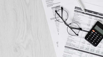 Office desk with supplies calculator pen notepad keyboard and chart ,glasses.selective focus,vintage color