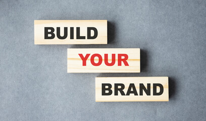Build your Brand written on wooden blocks with vintage styled background. Branding rebranding marketing concept.