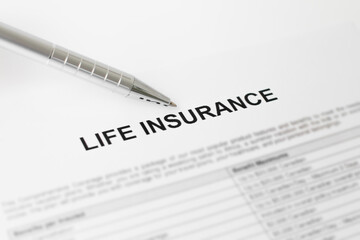 Life insurance document with pen nearby