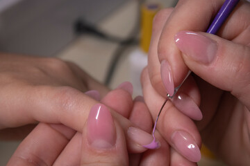 the process of doing manicure. Closeup of hands of professional manicurist, applying nail polish. Concept of doing manicure and fingernails cleaning. beauty concept. Gel polish, shellac