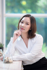 Fototapeta premium Portrait of beautiful asian woman at the coffee shop,Relax time,Thailand people working