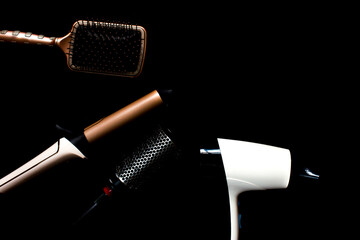Professional hair dresser tools. Hairdresser tools on black background with copy space in center....