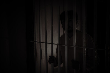 Hands of men desperate to catch the iron prison,prisoner concept,thailand people,Hope to be free.