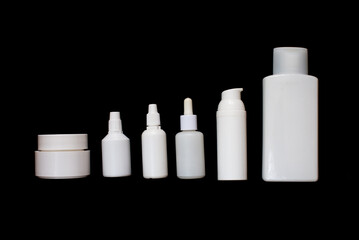 Simple Blank white Plastic Cosmetic Bottles Set.set of cosmetic products on a black background. Cosmetic package collection for cream, soups, foams, shampoo. Mock up white cosmetic bottles on black