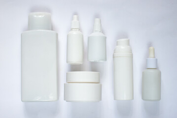 Simple Blank white Plastic Cosmetic Bottles Set.set of cosmetic products on a white background. Cosmetic package collection for cream, soups, foams, shampoo. Mock up white cosmetic bottles on white