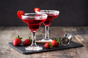 Strawberry margarita cocktail in glass on wooden table.	