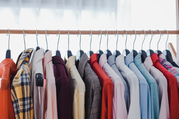 Row of clothes hanging on the rack.