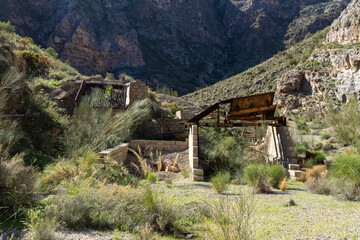 Old sand screening plant between mountains