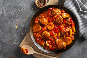 Meatballs with vegetables served on pan