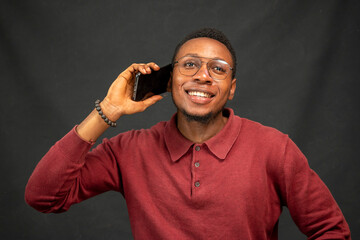 young black man making a phone call smiling