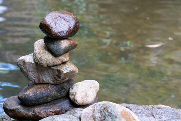 Fototapeta na wymiar Small stones that are stacked beside river for concept of spa.