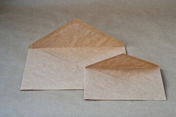 Top view of brown and green envelopes on grey background