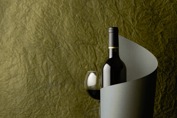 Bottle of red wine on a background of crumpled paper.